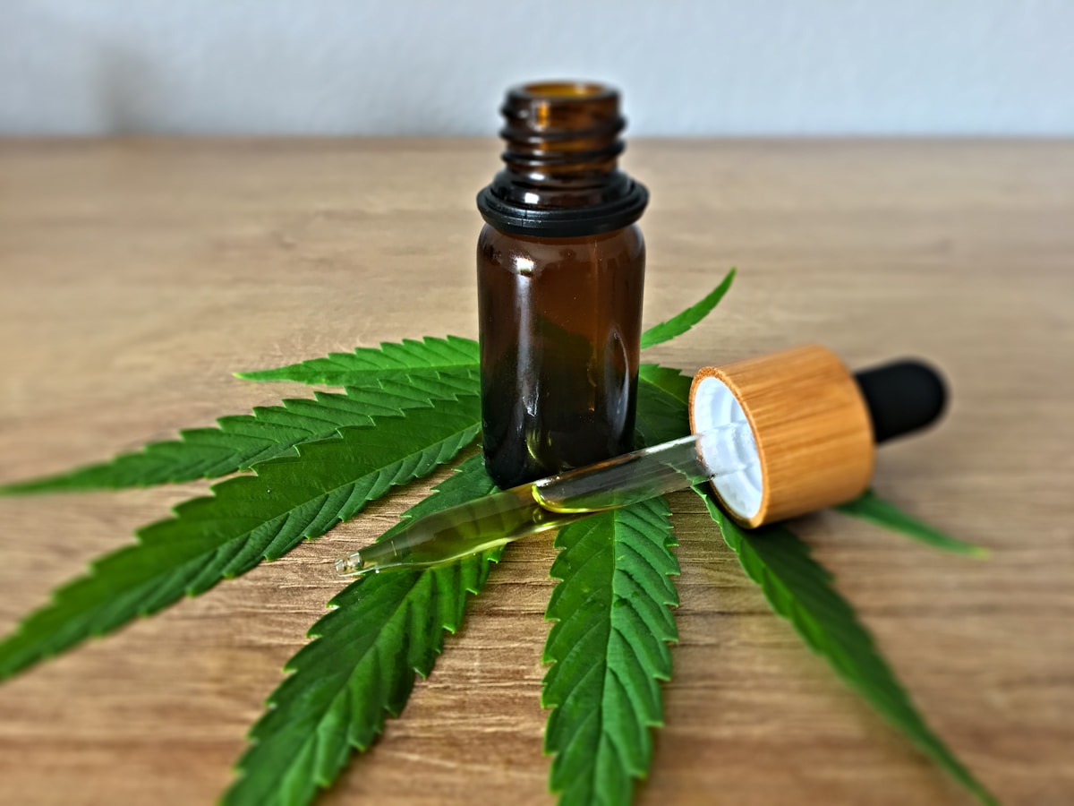 CBD oil bottle on wooden surface, full-spectrum hemp extract