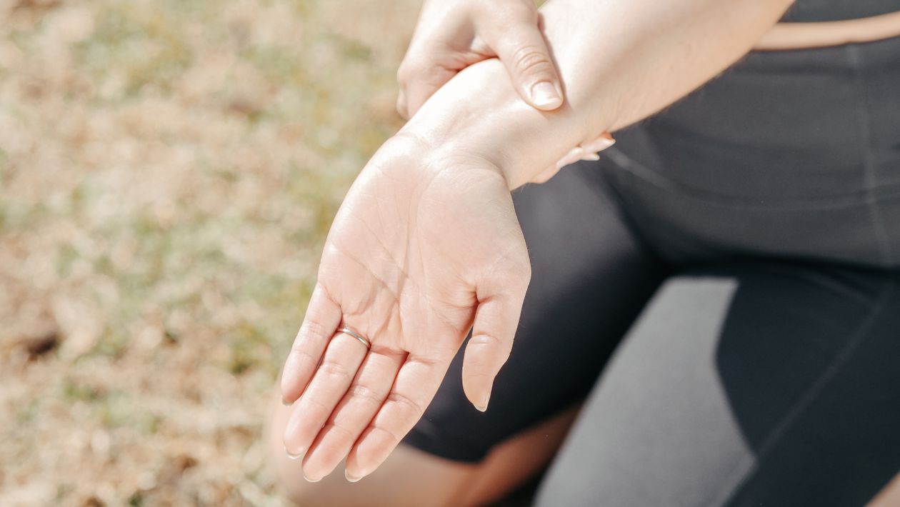 Woman experiencing joint discomfort alongside hormonal symptoms during menopause transition