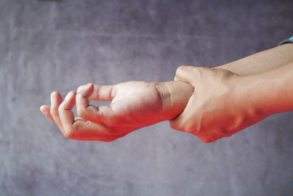 Hands affected by chronic nerve pain, a common reason people try CBD gummies for pain support