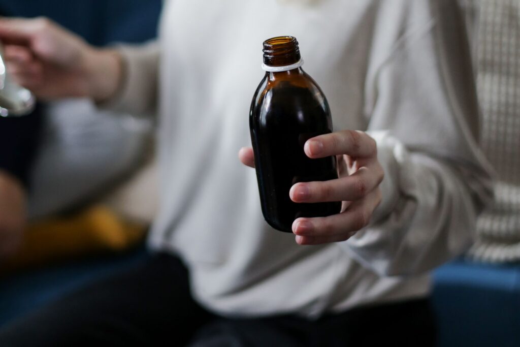 Checking the label and batch date on a CBD gummies bottle before buying