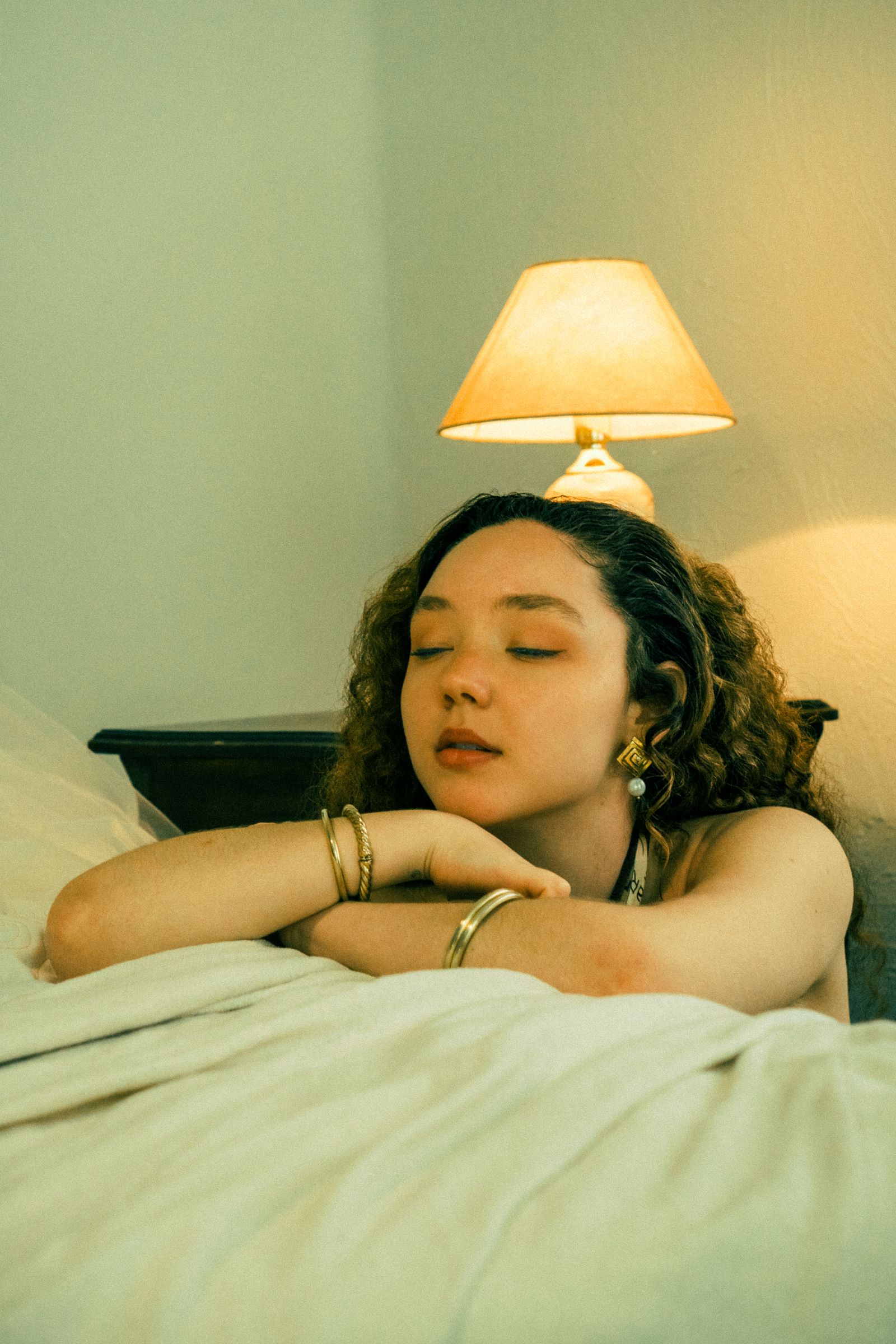 Woman relaxing by a warm lamp before an evening CBD dose