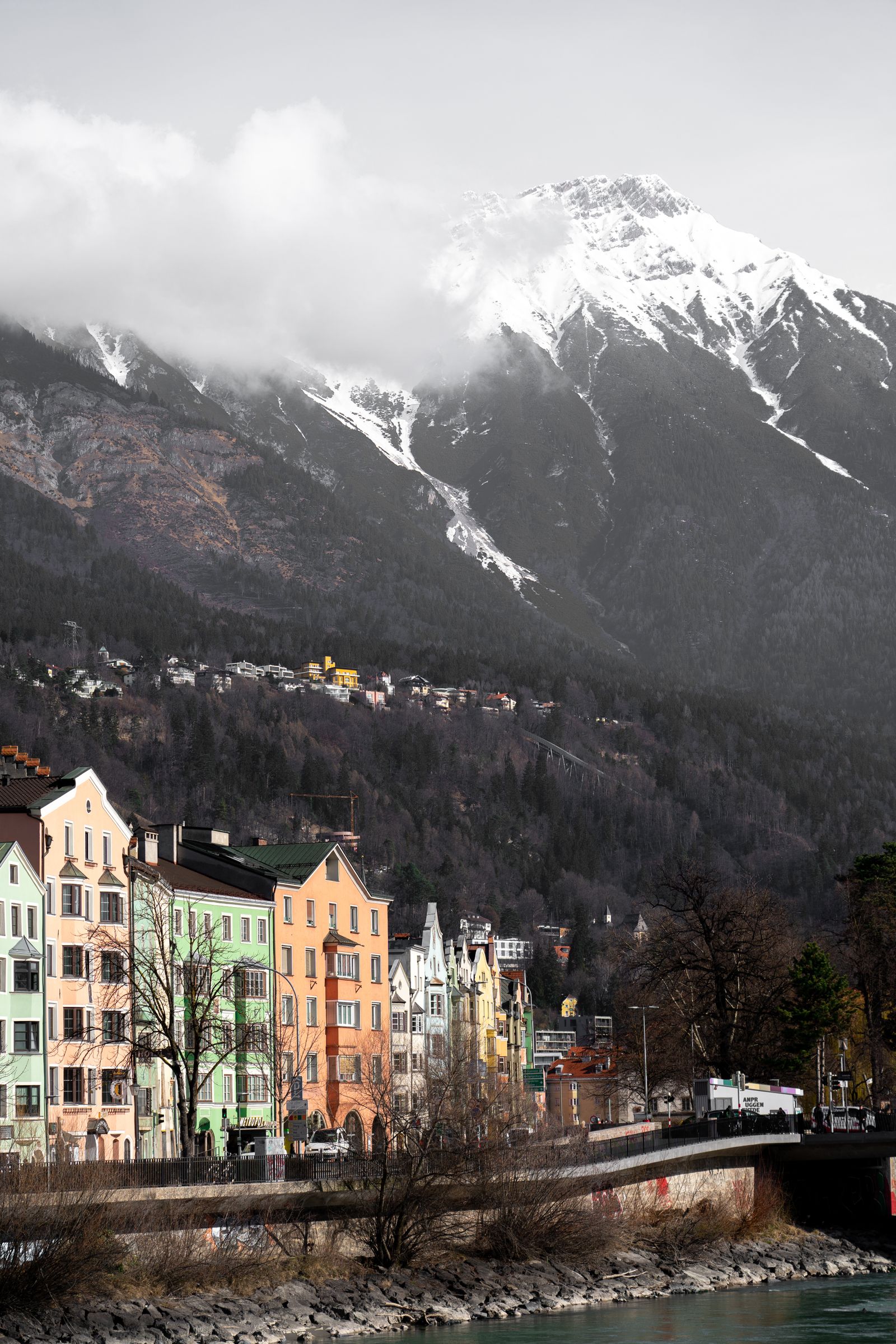 Innsbruck Austria with colorful buildings below snow capped Alps