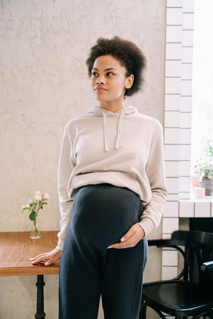Pregnant woman with hand on belly considering CBD safety