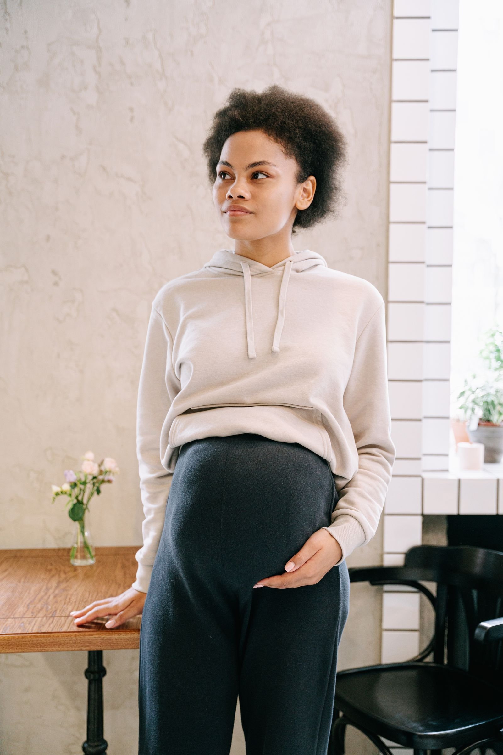 Pregnant woman with hand on belly considering CBD safety