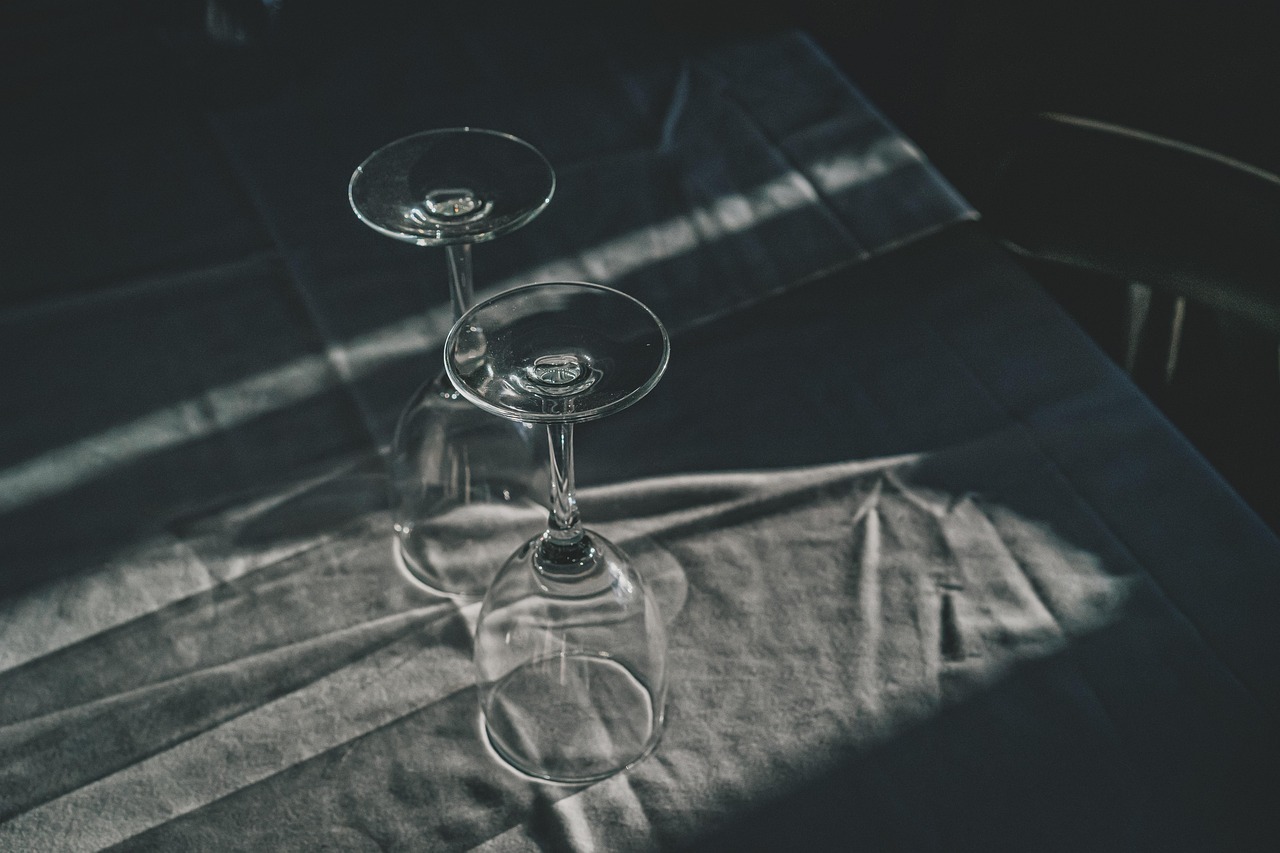 Empty wine glasses set on a table, a reminder to drink with caution