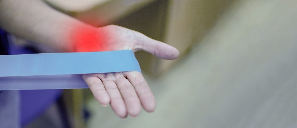Person wearing a wrist support for joint discomfort relief