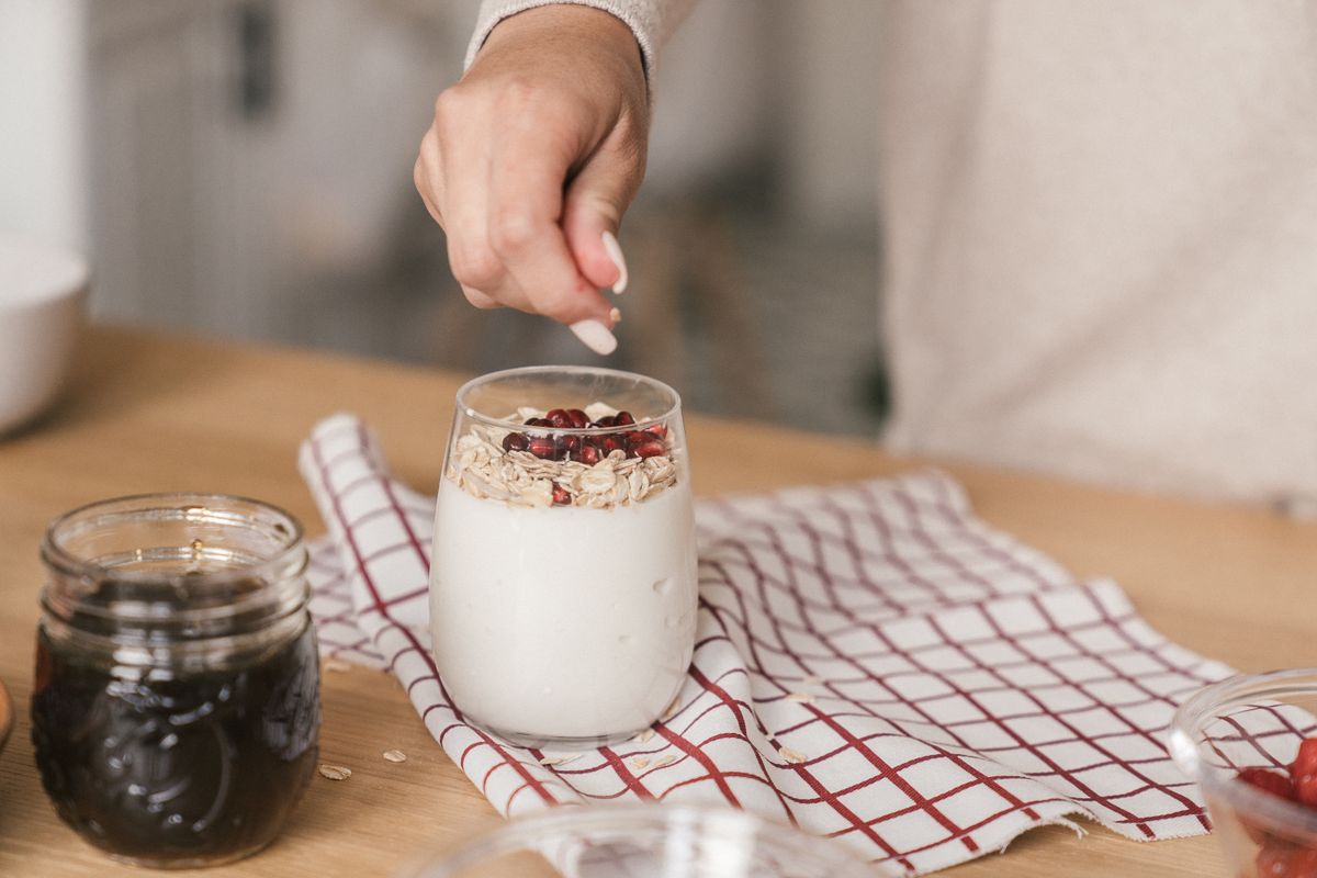 Yogurt bowl topped with granola and pomegranate for gut health