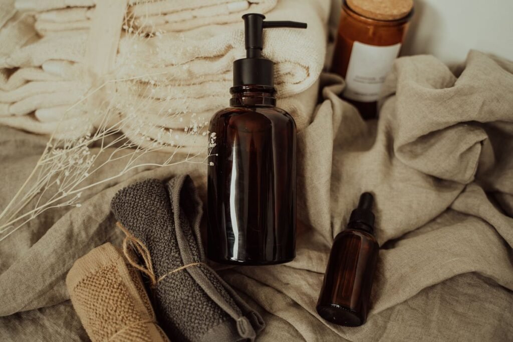 Amber CBD oil and dropper bottles on linen with towels, calm wellness setting for anxiety