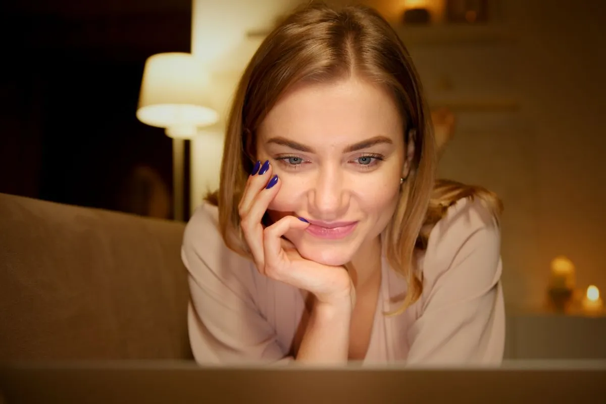 Woman relaxing at home in the evening with warm lamp light