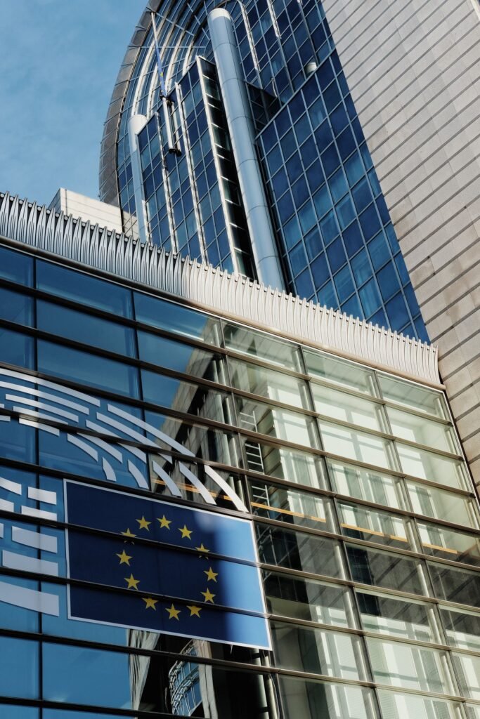 European Union flag on a glass building in Brussels, where CBD daily intake limits are being set