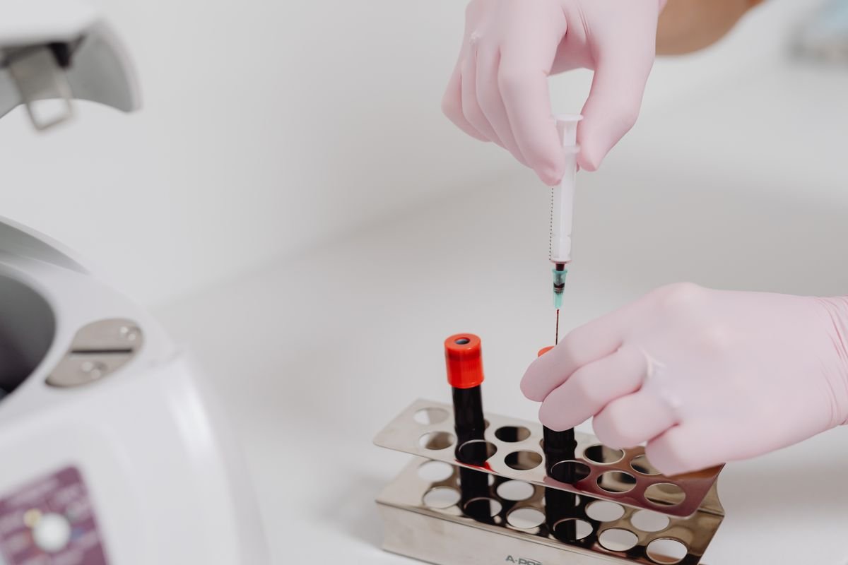 Gloved hands handling a laboratory sample for drug test confirmation