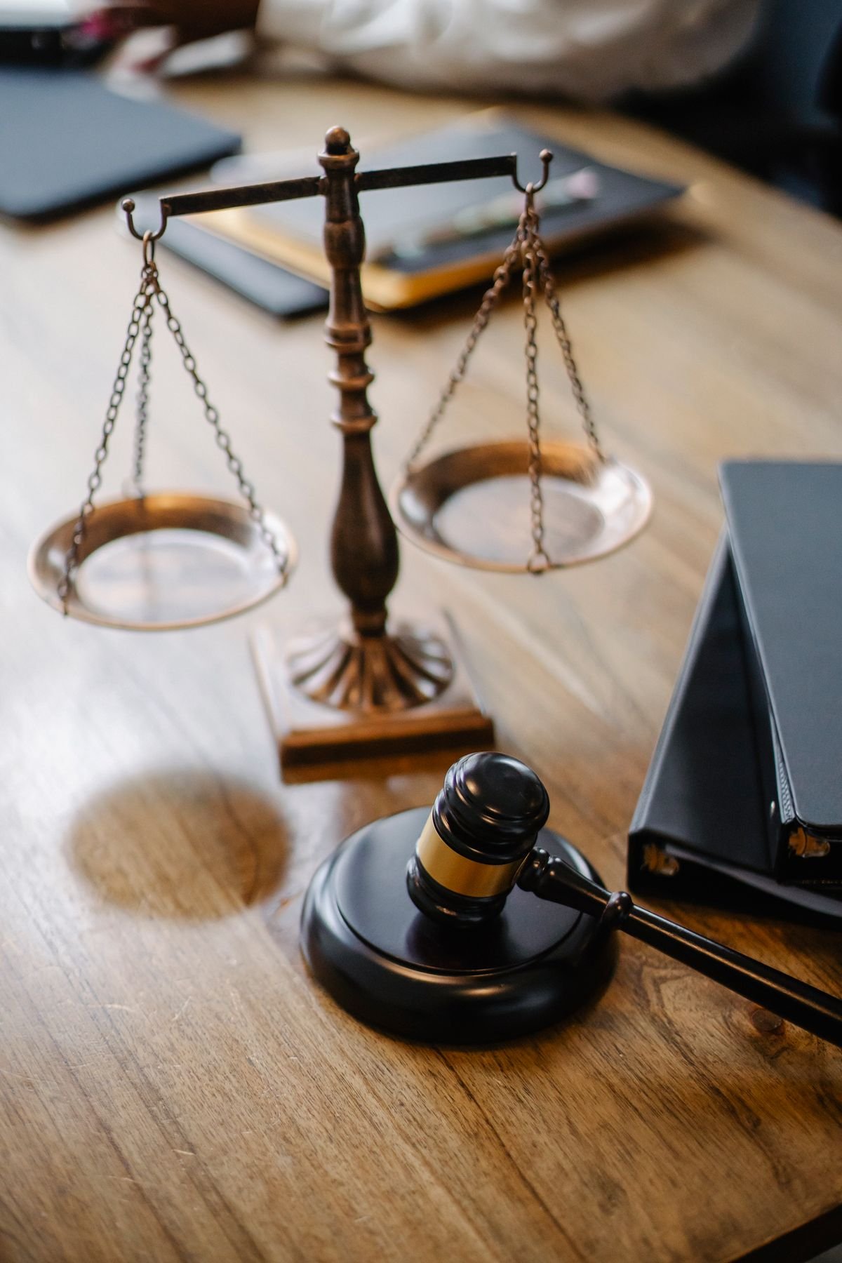 Scales of justice and a gavel on a wooden desk representing THC legal limits
