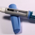 Semaglutide injection pen on a light surface, the drug sold as Ozempic and Wegovy