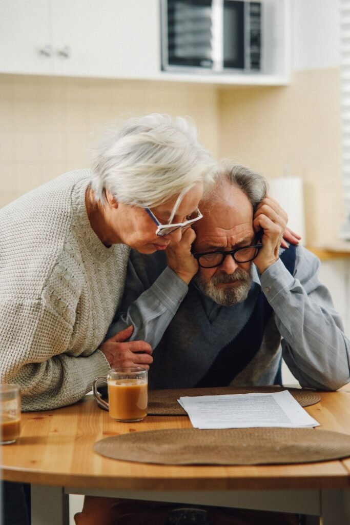 Worried couple reviewing paperwork and documents together at a table